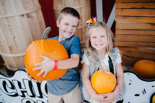 Boy and Girl Carrying Pumpkin